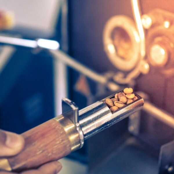Detailed view of coffee beans being roasted in a professional coffee roaster.
