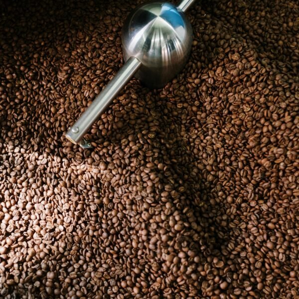 Detailed image of roasted coffee beans spinning inside a professional coffee roaster.